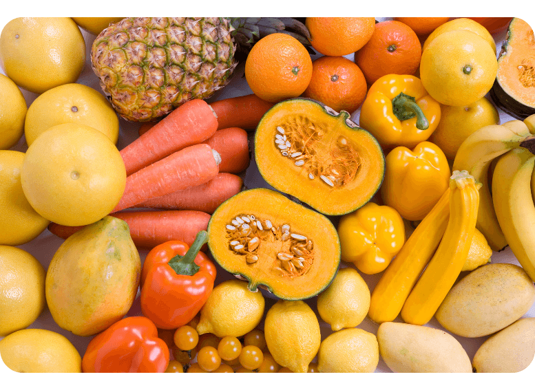 Żółte i pomarańczowe owoce i warzywa w diecie pudełkowej – źródło beta-karotenu i witaminy C wspierających odporność i zdrowie skóry